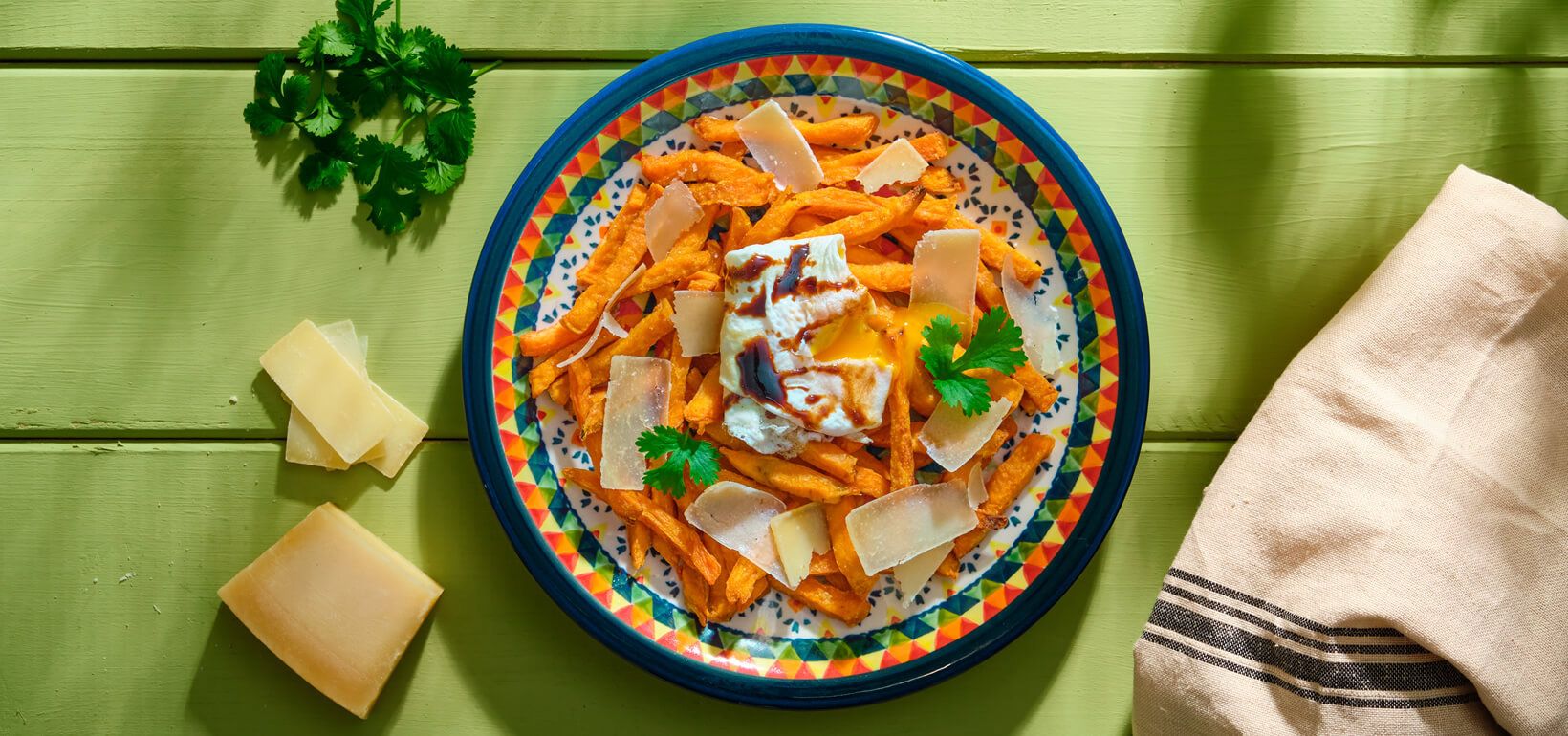AVIKO Sweet potato fries with pan-fried poached egg, mature cheese and balsamic vinegar cream